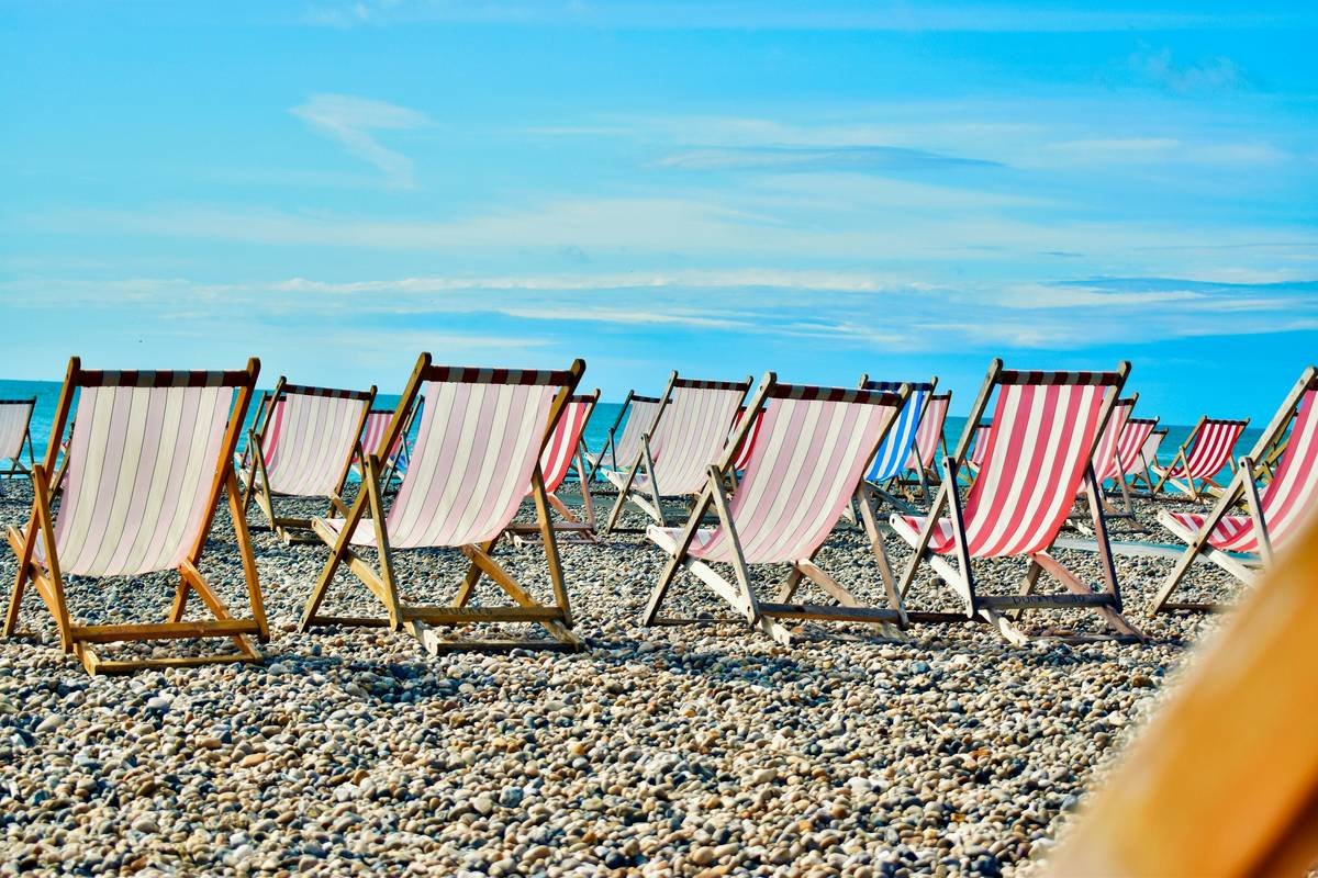 Beach chairs on a pebble beach in Beer, England