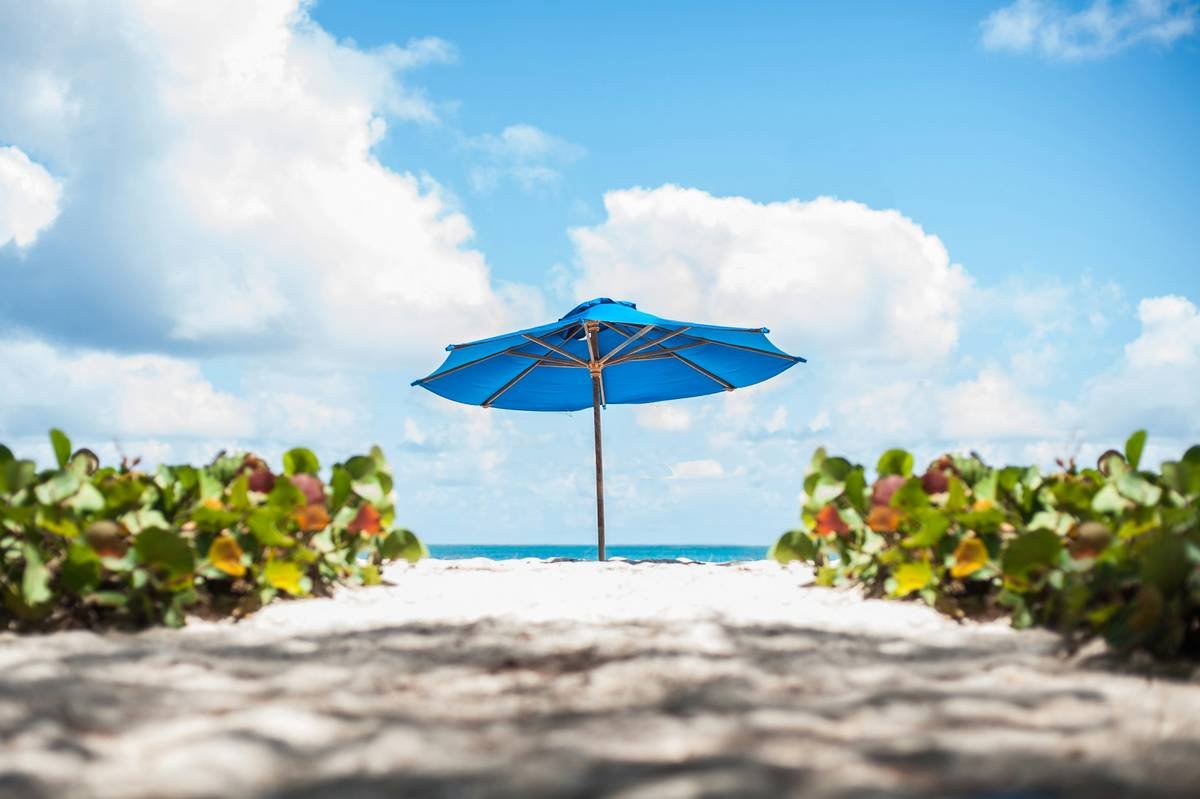 Weighted beach chair with umbrella for beach chair showing enhanced stability in breezy conditions